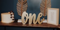 a table with a cake and a gold sign