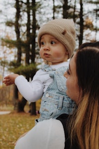 a woman holding a baby in her arms