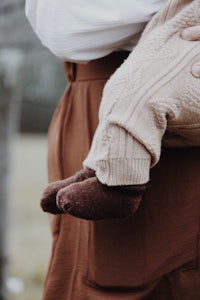 a woman holding a baby in her arms