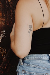 a woman with a flower tattoo on her back