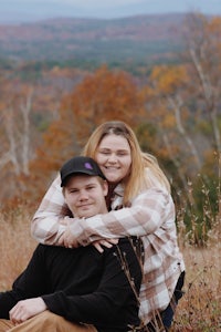 a man and a woman hugging in a field