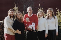 a family posing for a photo in front of a christmas tree