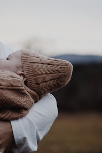 a woman is holding a baby in her arms