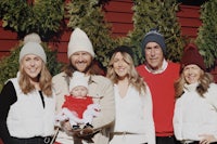 a family posing for a photo in front of a christmas tree