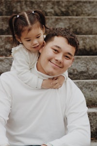 a man and a little girl sitting on steps