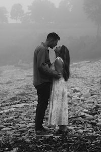 a couple kissing on a foggy beach