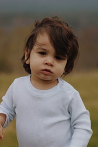 a child is playing with a frisbee in a field