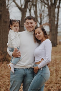 a family posing for a photo in the woods