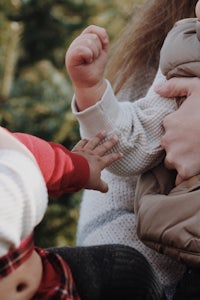 a woman is holding a baby in her arms