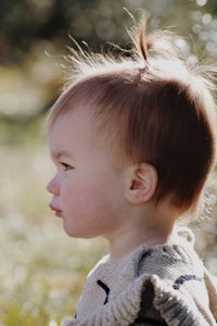 a child is standing in a field